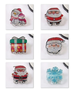 Detailed grid of Christmas hair claws featuring snowman, Santa, and glittery snowflakes