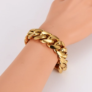 Bold gold stainless steel Cuban link bracelet for men shown on a hand model