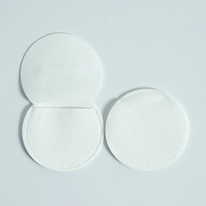 Detail view of round white microfiber jewelry pouches showing pocket structure and texture
