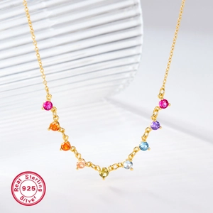 Detail of s925 silver gold-plated necklace featuring vibrant rainbow round cubic zirconia