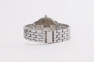Detailed view of silver metal watch strap with brick-style links and secure buckle closure