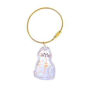 Transparent cat-shaped capsule keychain with orange tabby pattern and gold wire loop