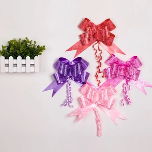 Detailed view of four colorful decorative bows with rose patterns for wedding car decor