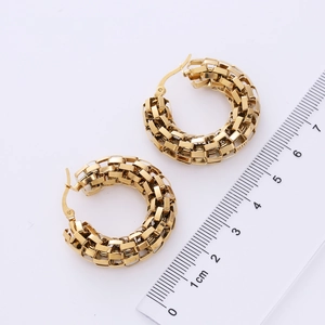 Detail showing 3cm gold woven hoop earrings next to a ruler for size reference