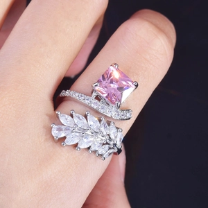 Macro detail of radiant cut pink gemstone ring with marquise zircon leaves on hand