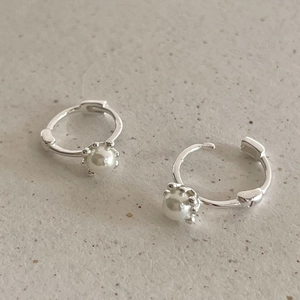 Minimalist 925 sterling silver hoop earrings with white pearls on textured background