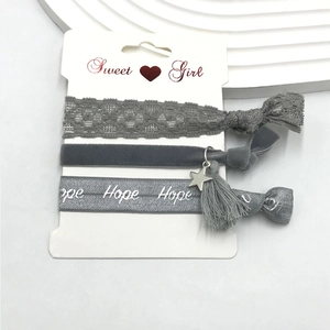 Three-piece grey hair band set with lace, velvet tassel, and Hope embroidery on card