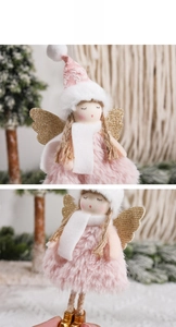 Detail of pink plush angel ornament with gold glitter wings and a soft knit hat
