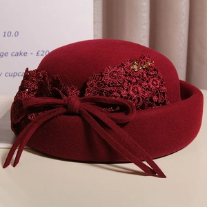 Elegant wine red wool beret with intricate lace flowers and a side bow detail