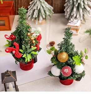 Close-up of mini Christmas tree ornaments with pine needles, red berries and gold balls