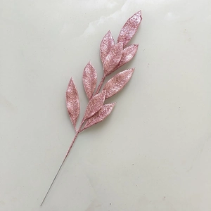 Detail of pink glitter artificial tree branch with sparkling metallic finish textures