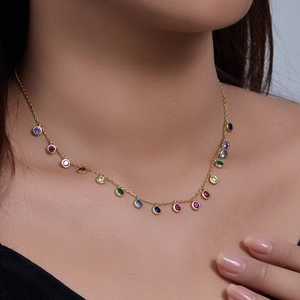 Close-up of a gold s925 silver necklace with multiple colorful round zircon gemstones