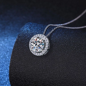 Macro view of sterling silver moissanite pendant with circular halo and small pavé stones