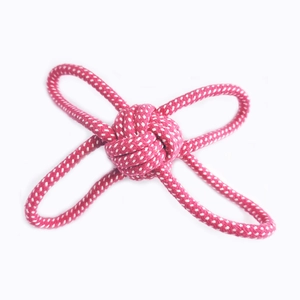 Macro detail of hand-woven fiber rope dog toy with monkey fist knot and handle