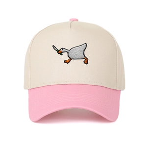 Detail of goose with knife embroidery on a beige and pink cotton baseball cap