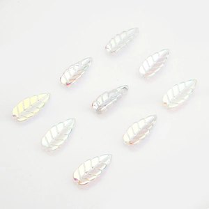 Macro shot of colorful leaf-shaped glass charms with iridescent finish for DIY jewelry