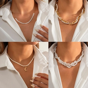 Detail view of four pearl necklaces including golden chains and crescent moon pendants
