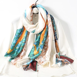 Elegant silk scarf with peacock and cloud patterns draped on a white shirt