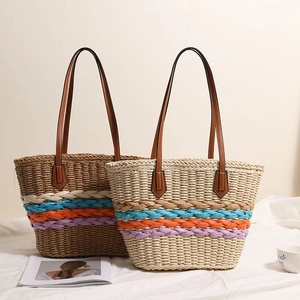 Bohemian straw tote bag with rainbow stripes and brown leather handles for beach vacation