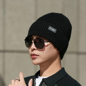 Men's winter knit beanie hat in black with fleece lining and FUMY logo patch