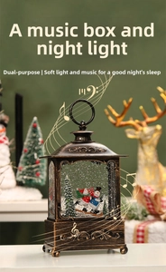 Detail of vintage Christmas music box with snowball scene and warm glowing LED light