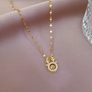 Golden titanium steel reindeer antler necklace with a dancing zircon stone pendant