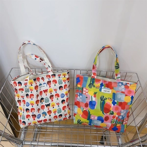 Floral and cartoon print canvas tote bags displayed in a metal wire shopping basket