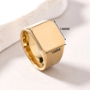 Detail view of a 14mm square gold signet ring made of polished stainless steel