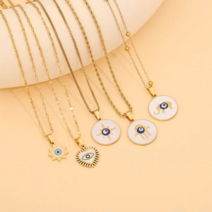 Golden Evil Eye necklaces set with star, Hamsa, heart, and elephant charms for women
