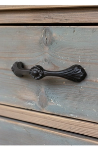 Detailed close-up of retro black cast iron handle with embossed texture on wood