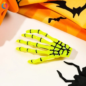 Close-up of fluorescent green skeleton hand hair clip with black bone detail for Halloween