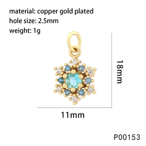 Detail of snowflake pendant in copper gold plated with blue and white cubic zirconia