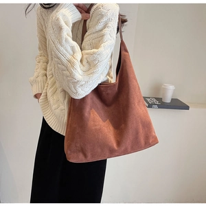 Brown frosted tote bag with thin leather straps shown on model in urban commute style