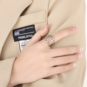 Wide two-tone grid hollow ring in stainless steel for women with modern woven design