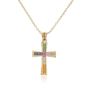 Macro view of a 18K gold plated cross necklace with vibrant colorful zircon stones