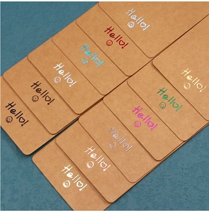 Macro detail of kraft paper jewelry display cards with colorful hot foil Hello text