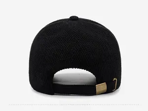 Close-up of the adjustable metal brass buckle and texture on black baseball cap