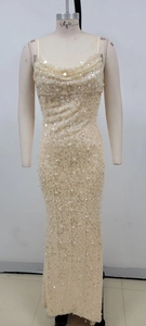 Detail of elegant champagne evening gown featuring delicate sequins and white pearl accents