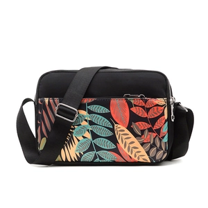 Black Oxford cloth shoulder bag with colorful leaf print and adjustable strap