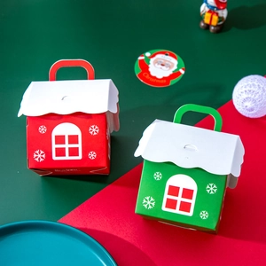 Red and green house-shaped Christmas candy gift boxes with festive snowflake patterns