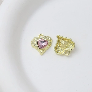 Detailed view of pink heart pendant with gold base showing front and textured back