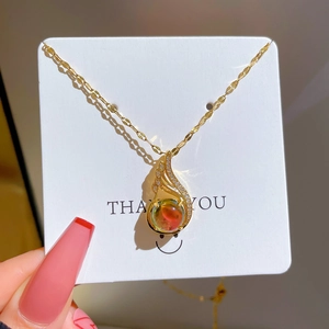 Elegant gold titanium necklace with phoenix feather pendant and gradient round stone