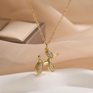 Elegant gold-plated balloon dog pendant necklace with sparkling crystal inlay on thin chain
