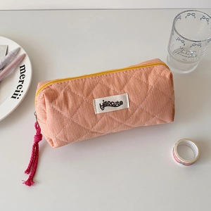 Detail of orange plaid quilted fabric stationery bag with pink woven zipper puller