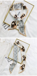 Detail of cream silk ribbon scarf with abstract female silhouette prints and golden decor