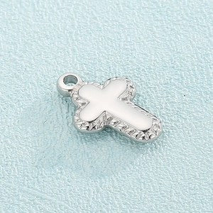 Polished silver stainless steel cross pendant with decorative textured edges