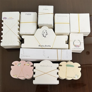 Assorted jewelry display cards for necklaces and hair clips in various shapes and designs