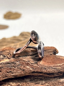 Macro shot of vintage adjustable ring featuring raw black tourmaline and hammered metal