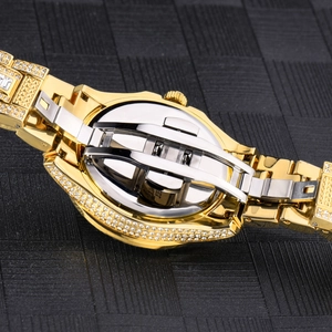 Close-up of gold-plated iced out watch back with stainless steel folding buckle