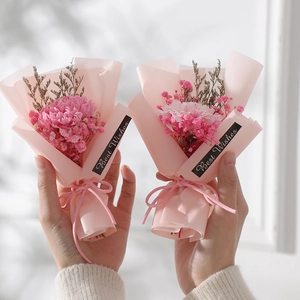 Mini dried sunflower and gypsophila bouquet in pink wrapping with Best Wishes tag